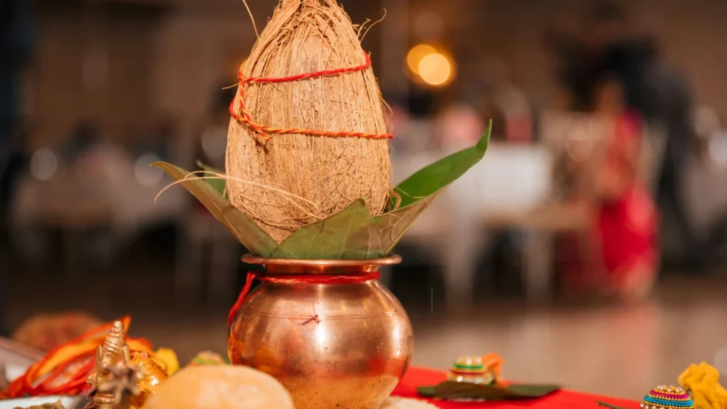 Why is coconut placed on the top of the Kalash